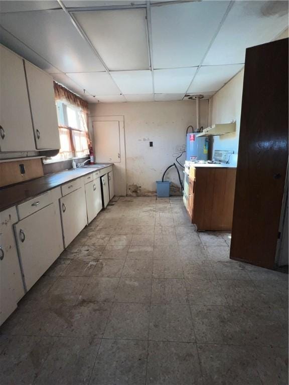 kitchen with white cabinetry and a drop ceiling