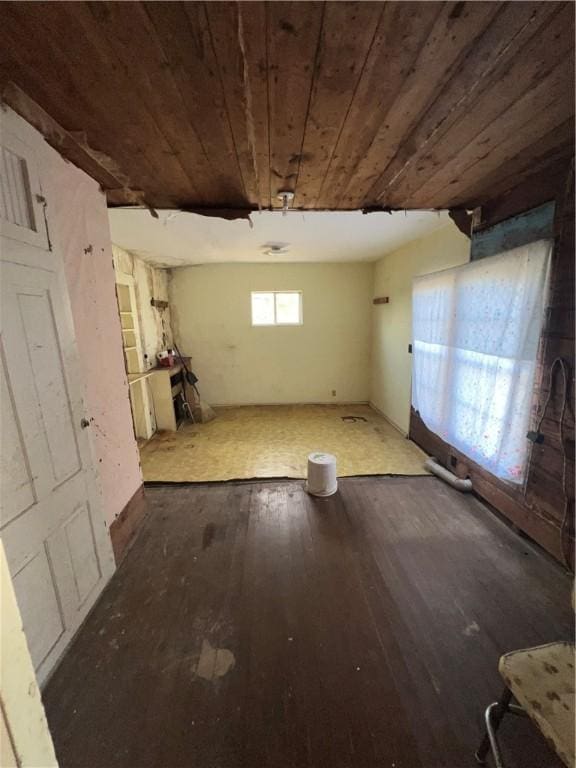 basement with dark hardwood / wood-style floors and wooden ceiling