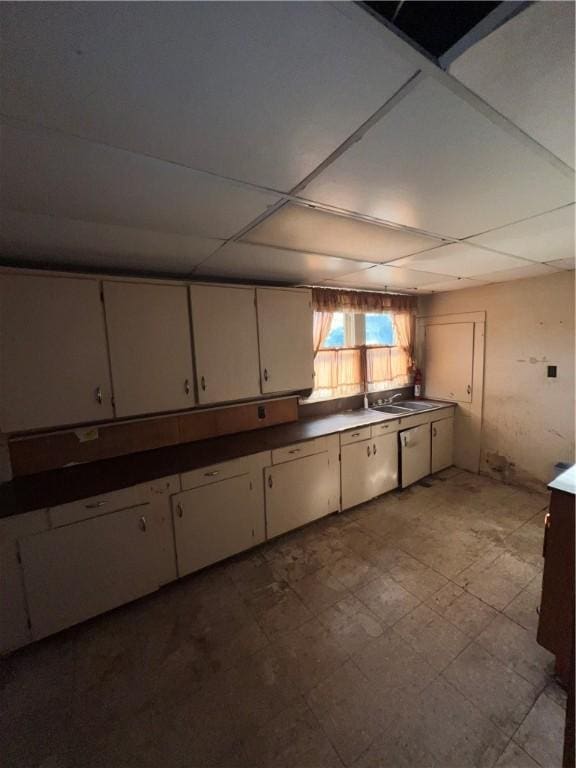 kitchen featuring sink and white cabinets