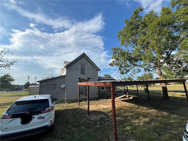 view of side of home with a lawn