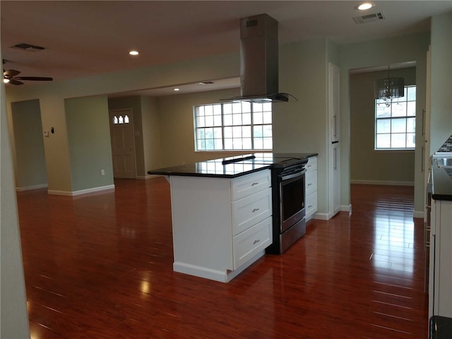 kitchen featuring white cabinets, dark wood-type flooring, stainless steel electric range, and ventilation hood