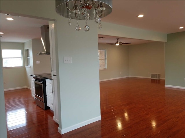 unfurnished room with ceiling fan and dark hardwood / wood-style flooring