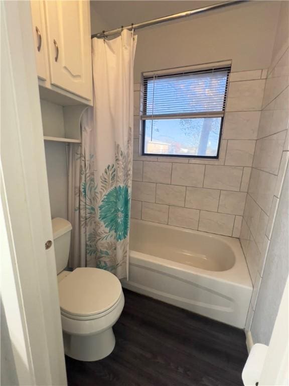 bathroom featuring wood-type flooring, shower / tub combo, and toilet