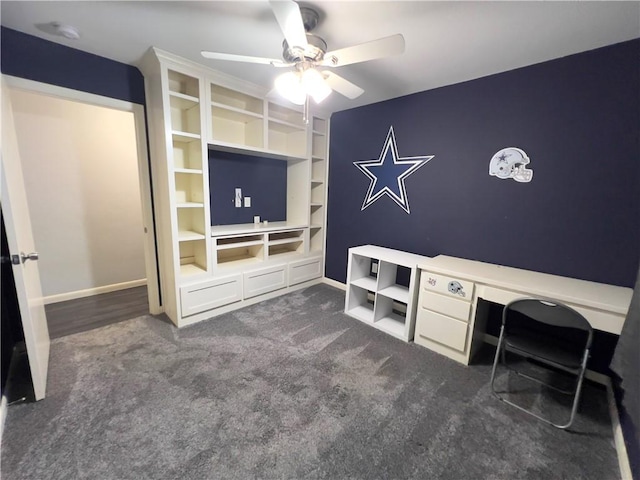 unfurnished office featuring dark colored carpet and ceiling fan