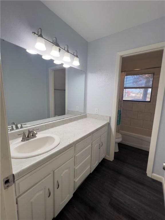 full bathroom featuring vanity, hardwood / wood-style flooring, toilet, and shower / tub combo with curtain