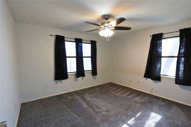 carpeted spare room with ceiling fan and a wealth of natural light