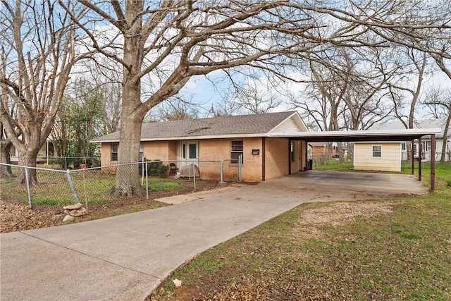 single story home with a carport, fence, brick siding, and driveway