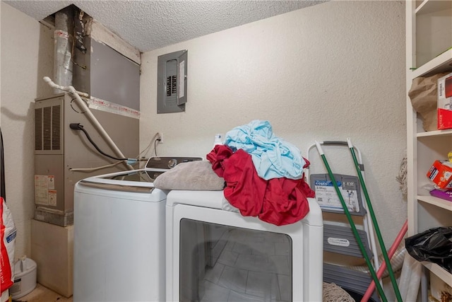 washroom with laundry area, electric panel, a textured ceiling, washer and dryer, and a textured wall