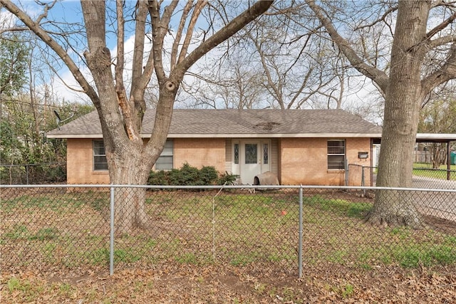 ranch-style home with a front lawn, brick siding, and a shingled roof