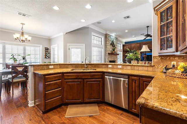 kitchen with a sink, visible vents, stainless steel dishwasher, and ornamental molding