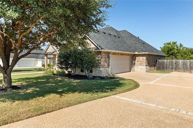 view of front of property with a front yard, fence, a shingled roof, stone siding, and brick siding