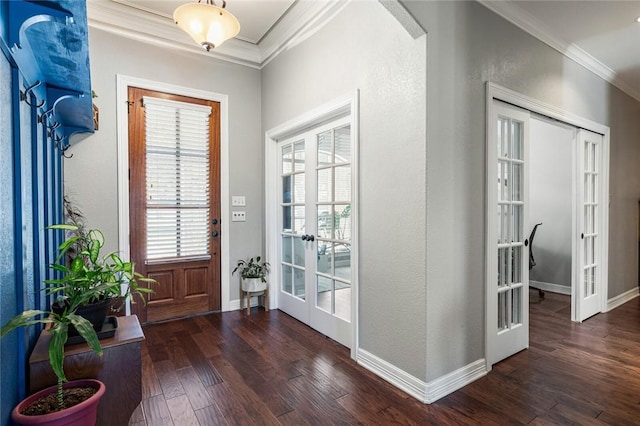 foyer entrance with french doors, wood finished floors, baseboards, and ornamental molding