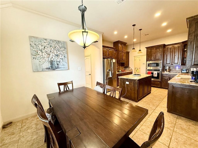 dining area featuring light tile patterned flooring and ornamental molding