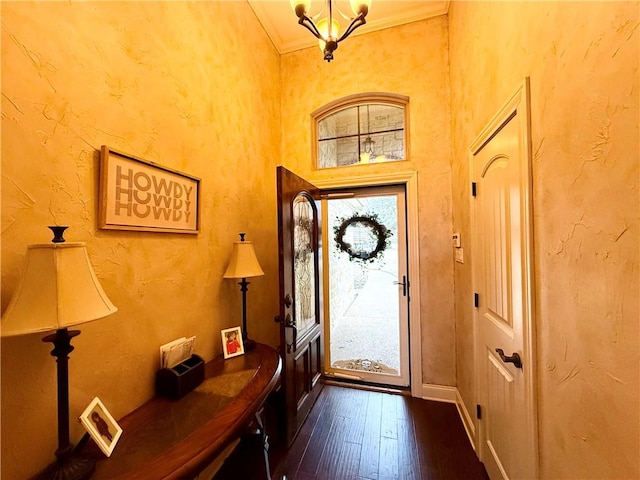 foyer entrance featuring dark hardwood / wood-style flooring and ornamental molding