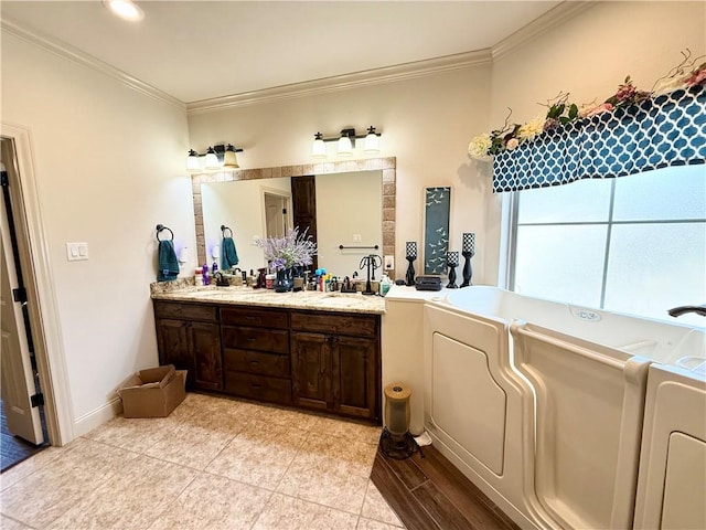 bathroom with crown molding, vanity, and separate washer and dryer