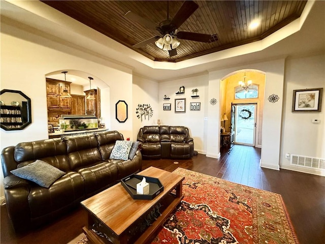 living room featuring ornamental molding, ceiling fan, wood ceiling, a raised ceiling, and dark wood-type flooring