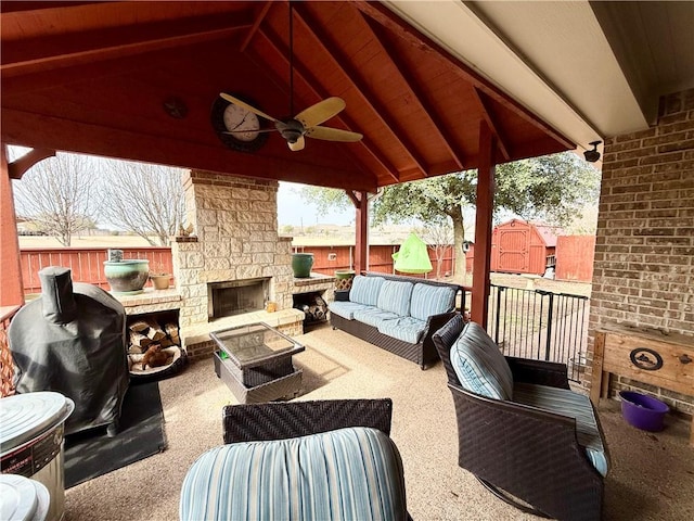 view of patio featuring an outdoor living space with a fireplace and ceiling fan