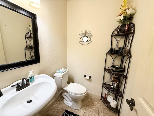 bathroom with sink, tile patterned floors, and toilet