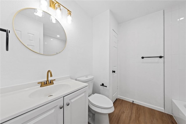 bathroom with hardwood / wood-style flooring, vanity, and toilet