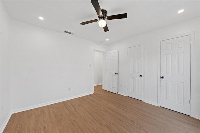 unfurnished bedroom with ceiling fan and light hardwood / wood-style flooring