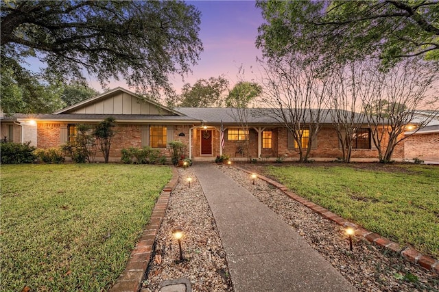 ranch-style home featuring a lawn