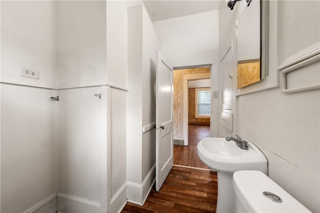 bathroom featuring hardwood / wood-style floors and toilet