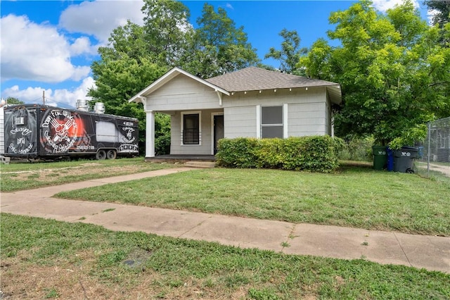 bungalow-style home with a front yard and a porch