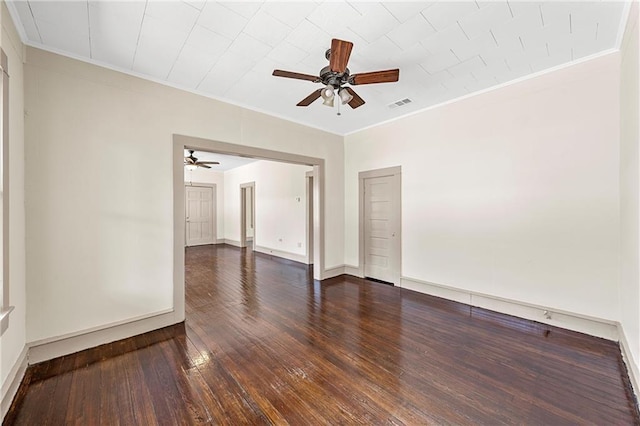 spare room with dark hardwood / wood-style floors, ceiling fan, and ornamental molding