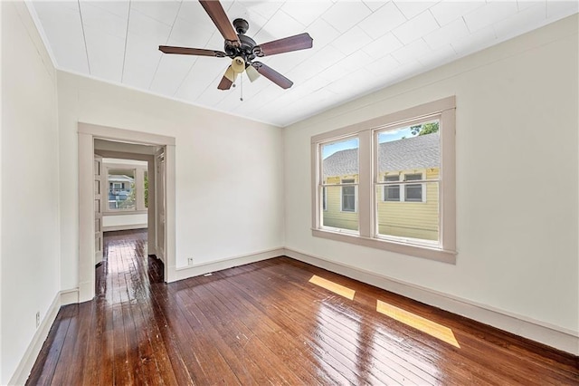 empty room with ceiling fan and dark wood-type flooring