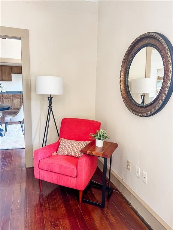 sitting room with dark wood-type flooring