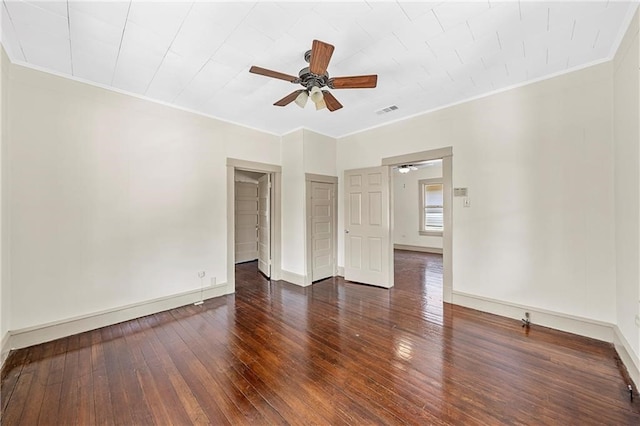 spare room with dark hardwood / wood-style floors, ceiling fan, and crown molding