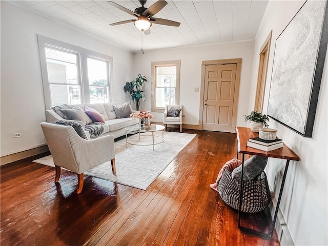 living room with dark hardwood / wood-style floors and ceiling fan