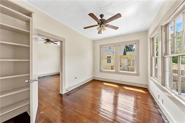 unfurnished sunroom with ceiling fan