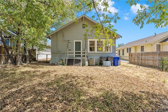 back of property featuring central AC