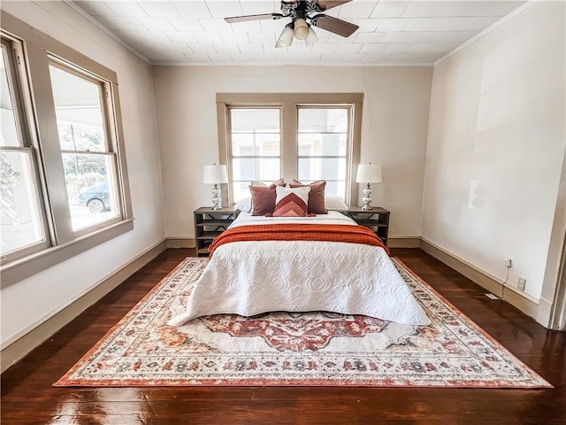 bedroom with ceiling fan, dark hardwood / wood-style flooring, and crown molding