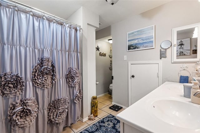 bathroom with tile patterned floors, vanity, and toilet