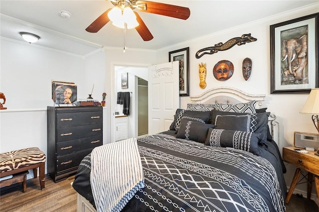 bedroom featuring hardwood / wood-style floors, ceiling fan, and crown molding