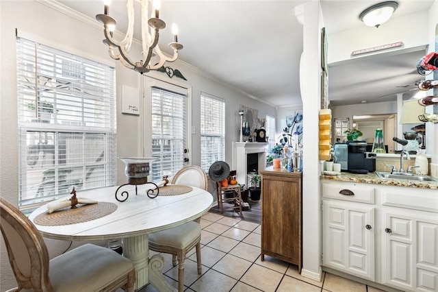 dining space featuring sink, light tile patterned floors, ceiling fan with notable chandelier, and ornamental molding