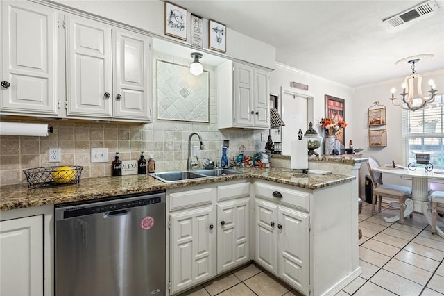 kitchen with sink, dishwasher, a notable chandelier, kitchen peninsula, and white cabinets