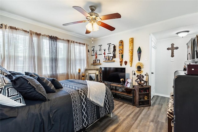 bedroom with hardwood / wood-style flooring, ceiling fan, and crown molding