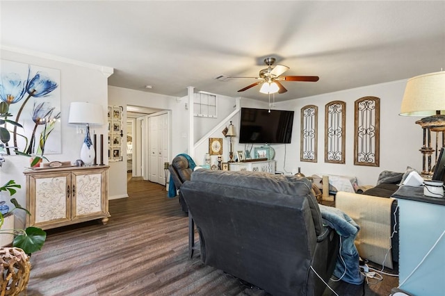 living room with dark hardwood / wood-style flooring, ceiling fan, and ornamental molding