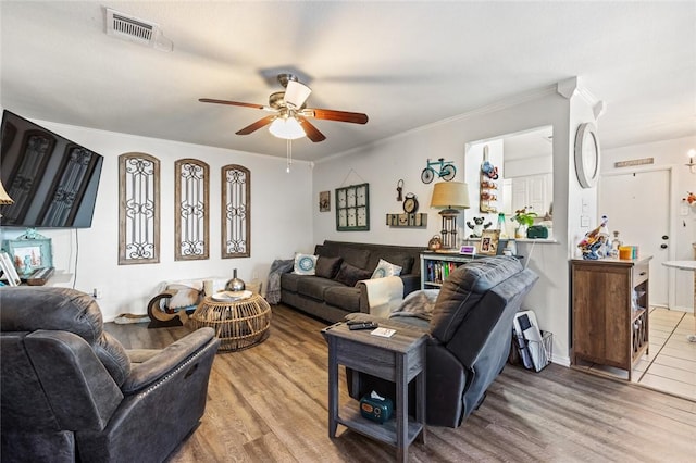 living room with crown molding, ceiling fan, and light hardwood / wood-style floors