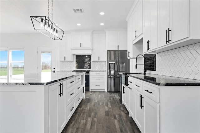 kitchen with stove, dark wood finished floors, stainless steel fridge with ice dispenser, and white cabinetry