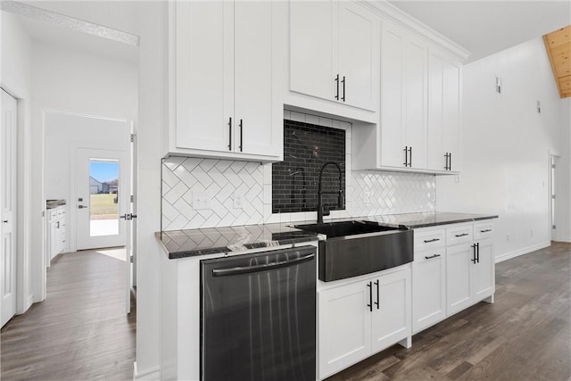 kitchen with dark wood-type flooring, a sink, dark countertops, white cabinets, and dishwasher