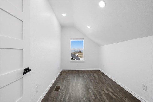 bonus room featuring visible vents, dark wood finished floors, recessed lighting, baseboards, and vaulted ceiling