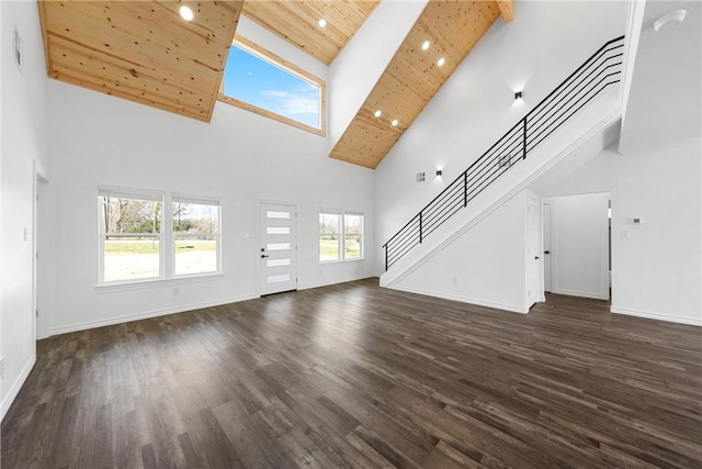 unfurnished living room with dark wood-style floors, baseboards, recessed lighting, stairs, and wooden ceiling