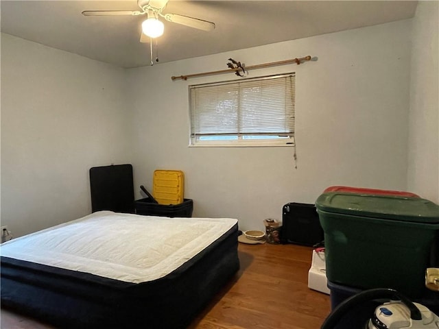 bedroom with ceiling fan and hardwood / wood-style floors