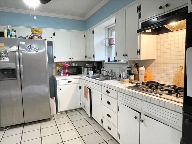 kitchen with ornamental molding, appliances with stainless steel finishes, sink, and backsplash