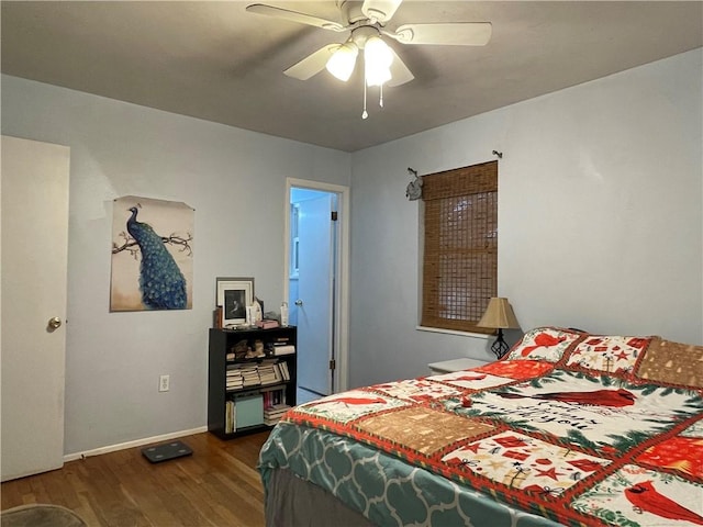 bedroom with dark hardwood / wood-style floors and ceiling fan