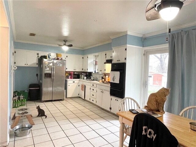 kitchen with white cabinetry, ornamental molding, light tile patterned floors, ceiling fan, and stainless steel refrigerator with ice dispenser